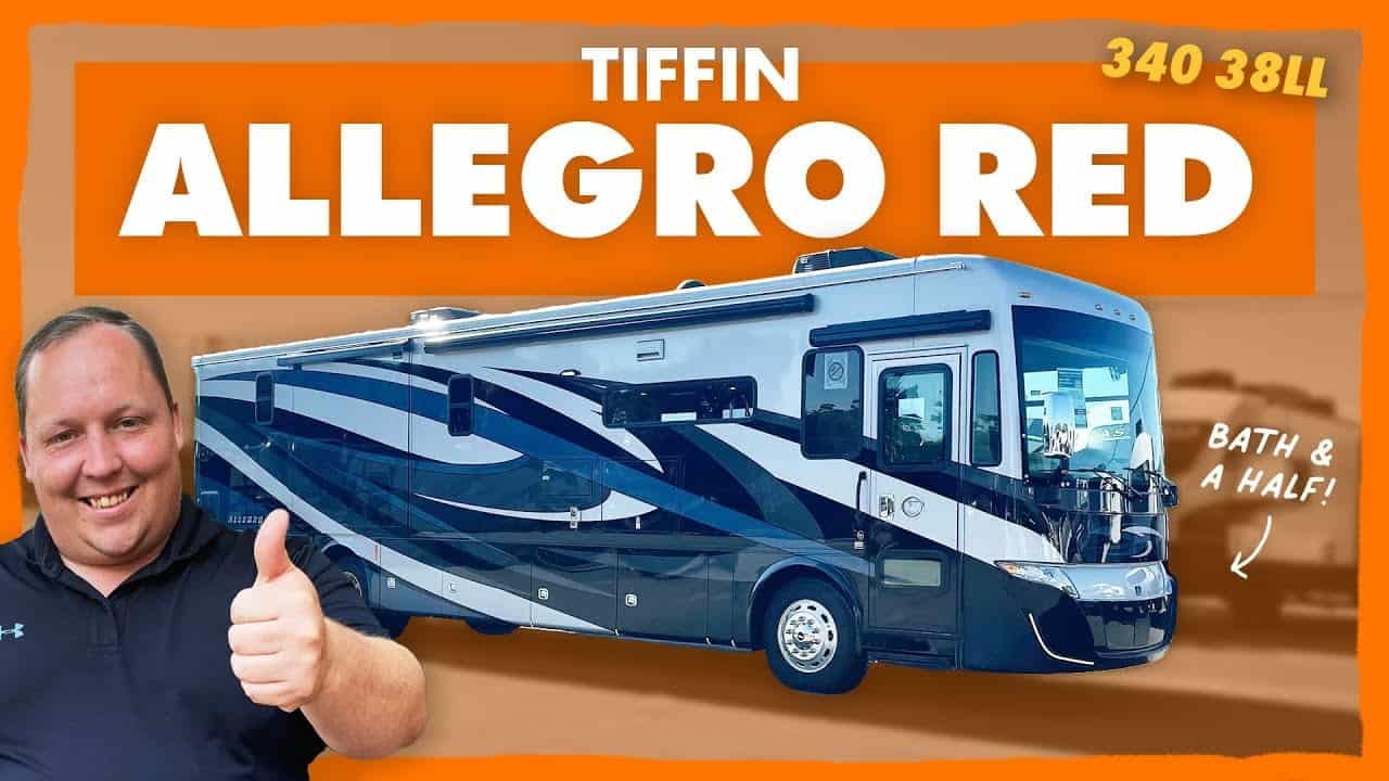 A man is giving a thumbs up in front of a Tiffin Allegro Red 340 RV.