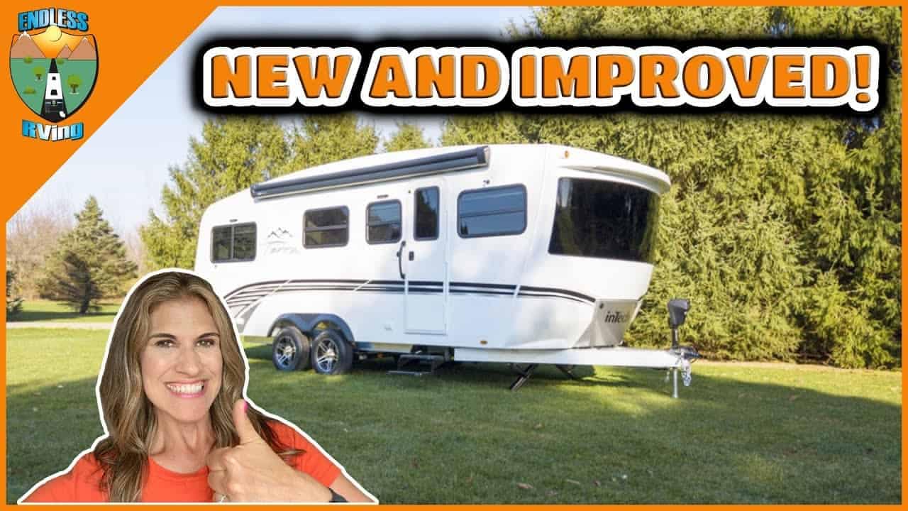 A woman is posing in front of a new and improved trailer with the words "InTech Terra Oasis" and "2022" prominently displayed.