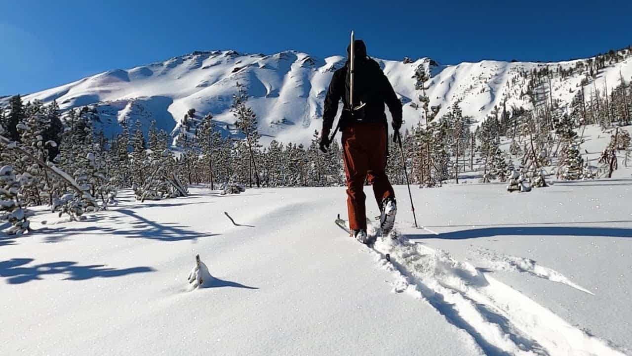 A person is skiing across a snow covered mountain while enjoying the thrill of winter sports.