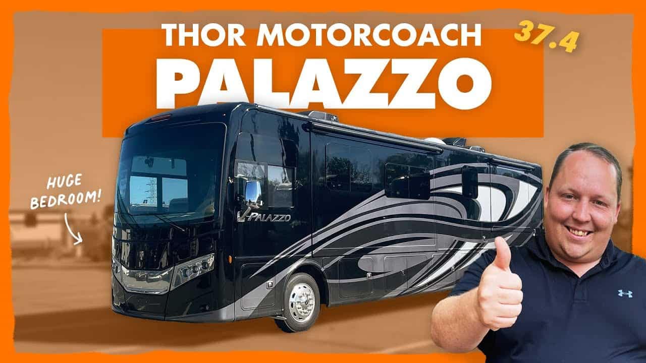 A man is giving a thumbs up to the cheapest RV, a Thor Motorcoach Palazzo diesel pusher.