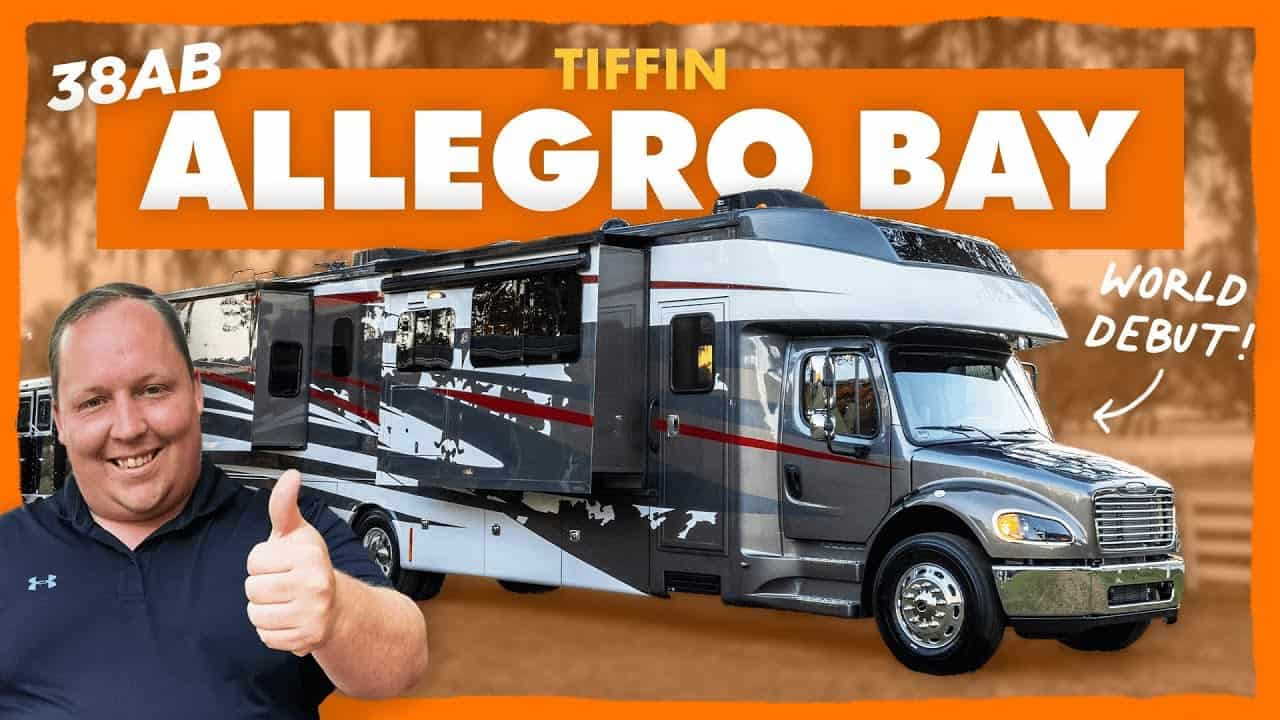 A man is giving a thumbs up to a Tiffin RV in Allegro Bay.
