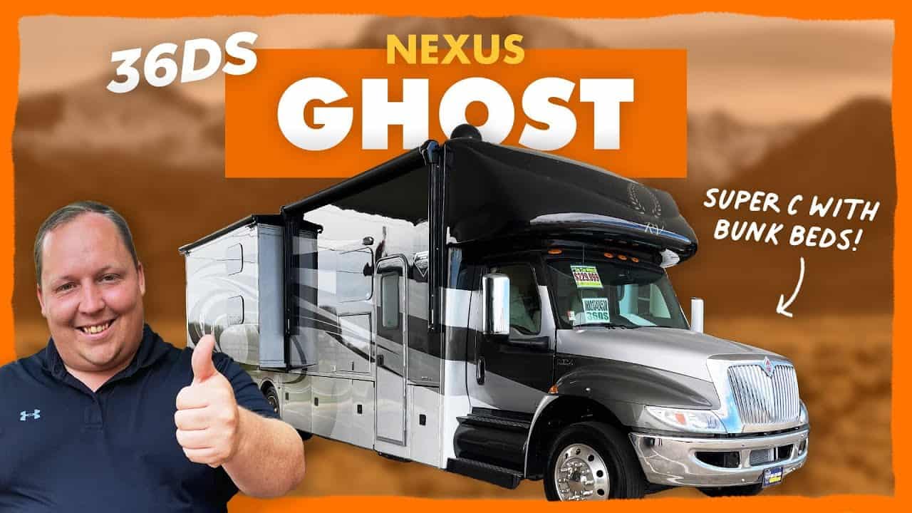 A man is giving thumbs up in front of a 2022 Nexus Ghost 36DS RV.