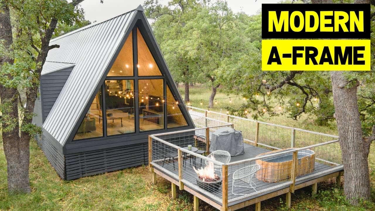 A modern tiny A-frame house in the woods.