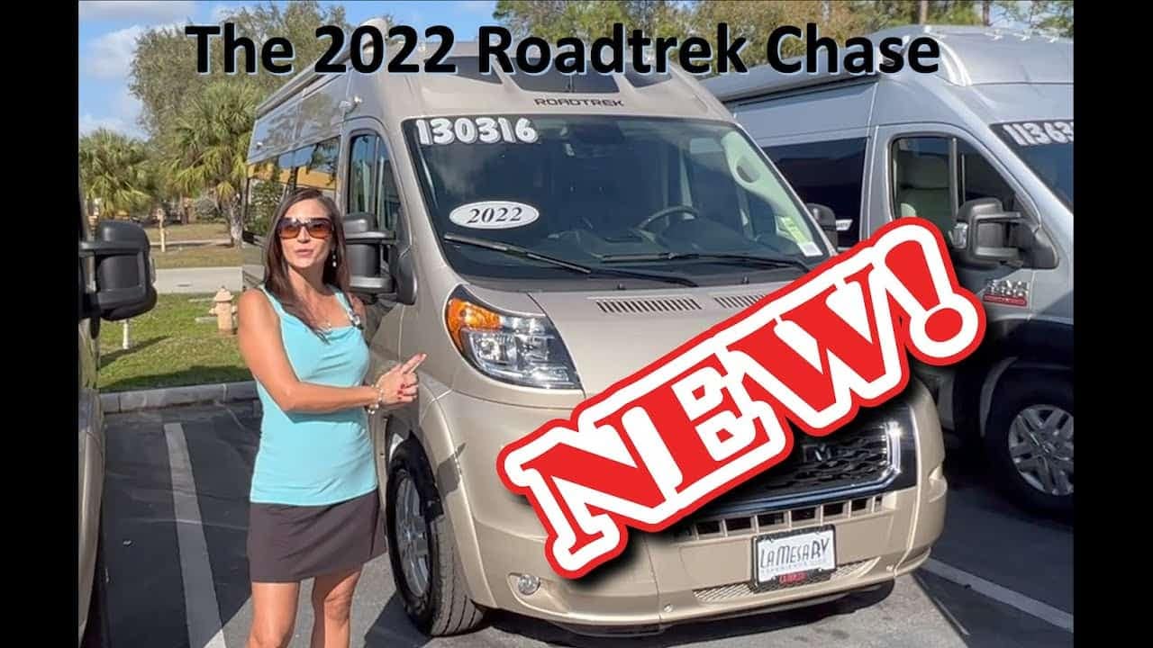 A woman is standing next to an All-New 2022 Roadtrek Chase B-Class RV, ready to tour.