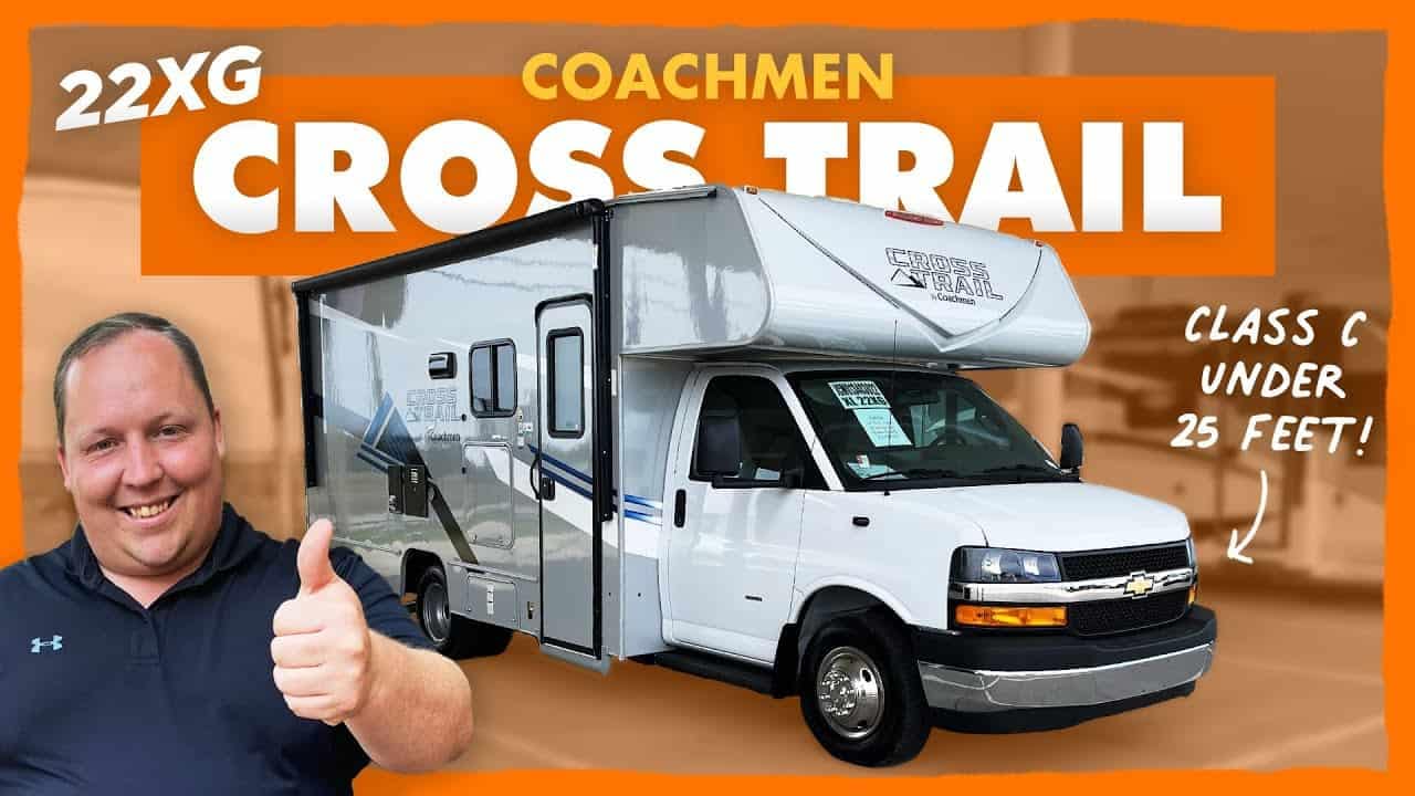 Description: A man is giving a thumbs up in front of a motorhome.
