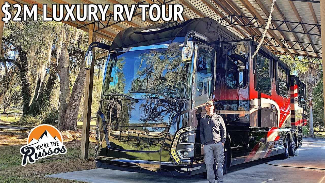 A man standing in front of a $2 million Custom Newell Luxury RV during an RV tour.