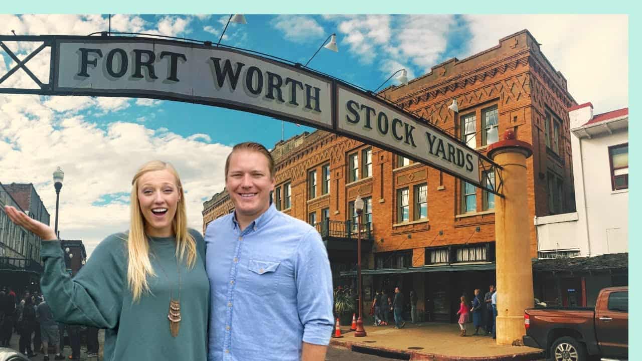 A man and woman RVing in front of the Fort Worth Stock Market, seizing opportunities and opening doors.