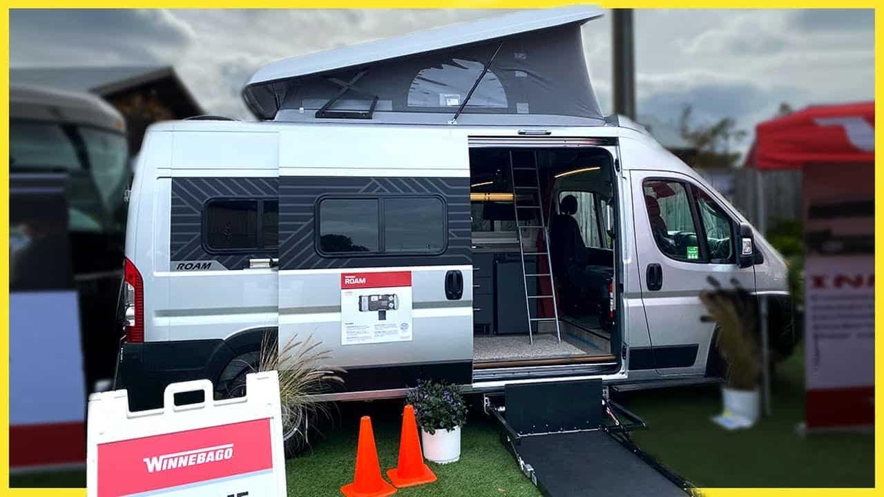 A Wheelchair-Accessible Camper Van with its door open at a show.