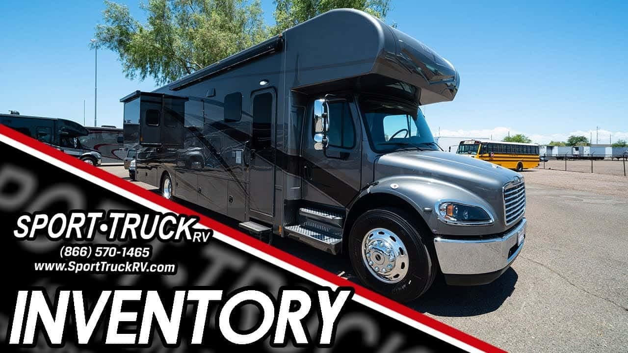 A black RV is parked in a parking lot, offering a glimpse of the 2022 Renegade Valencia 38RW during an RV tour.