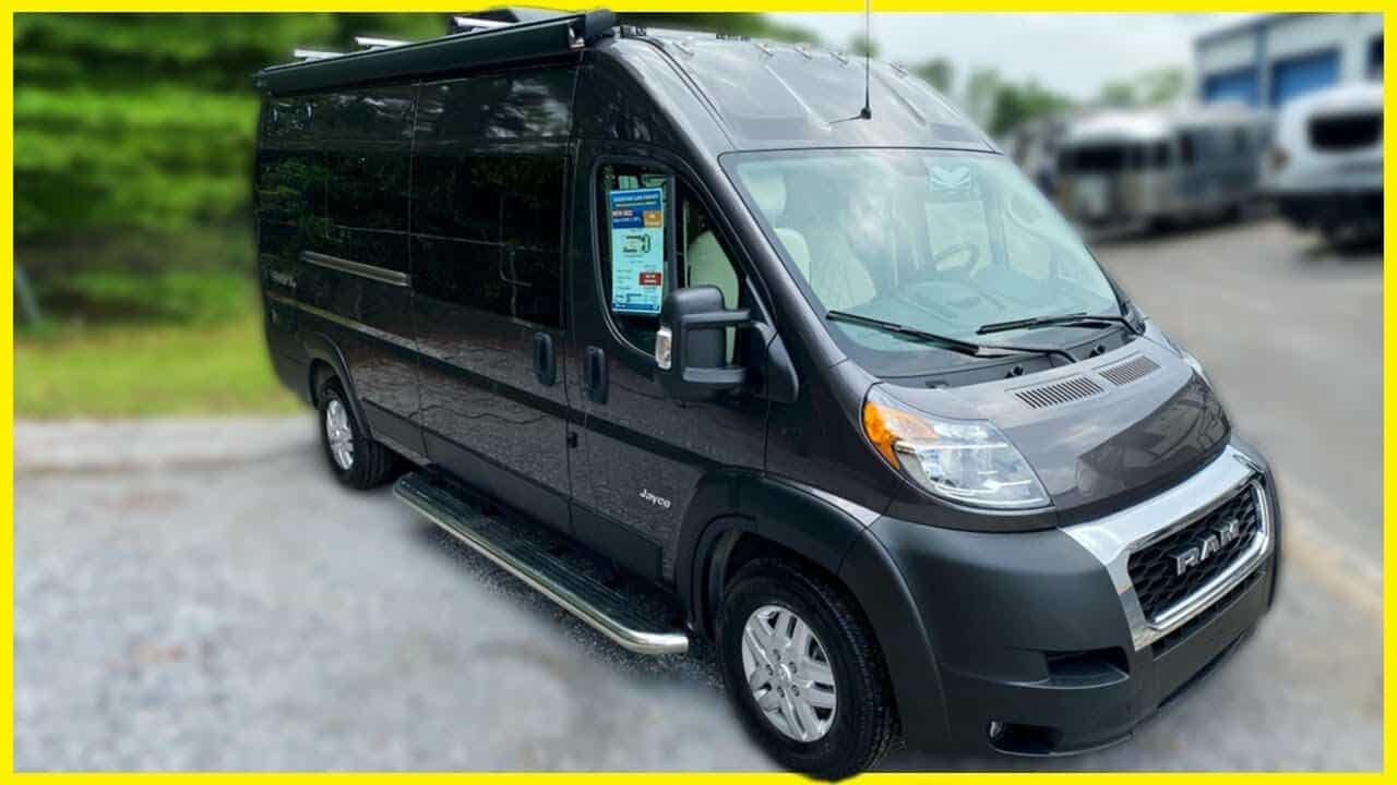 A black Promaster RV is parked in a parking lot.