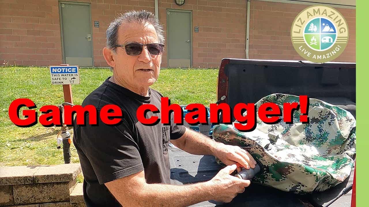 A man holding a bag with the words game changer near a sewer.