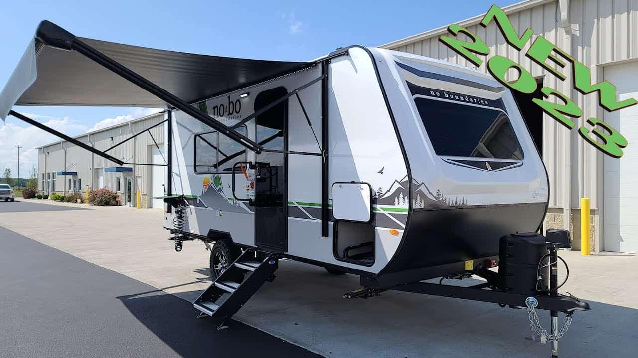 The New 2023 No Boundaries 19.2 Travel Trailer is parked in front of a building during an RV Tour.