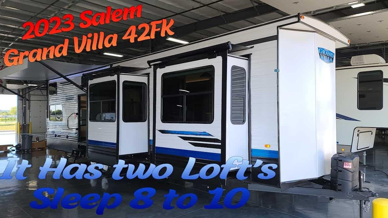 A 2023 Salem Grand Villa 42FK RV in a parking lot with a sign that says sleep 8 to 10.
