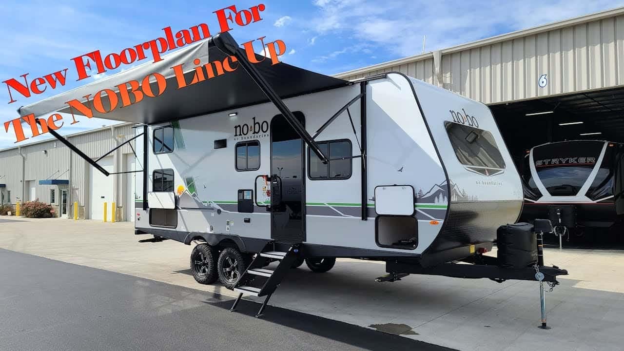 A brand new 2023 Morris RV is parked in a garage, showcasing its spacious interior in a captivating RV tour. With a sign that proudly states "New Morris for the world", this