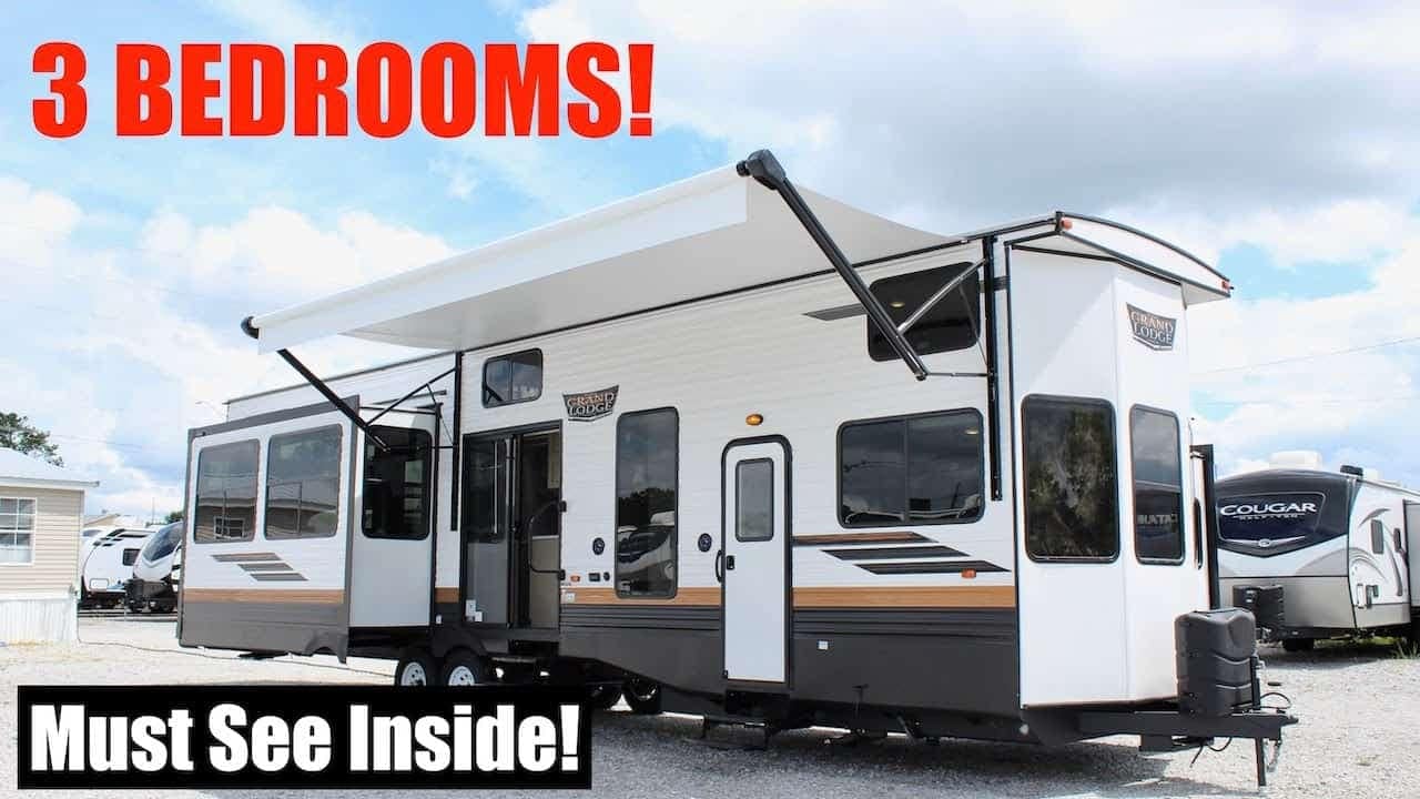 A Wildwood Grand Lodge RV with a sign that says you must see inside.