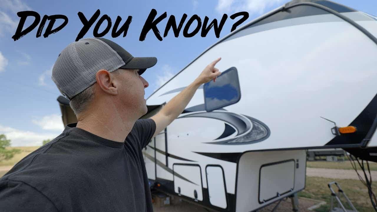 An experienced RVer pointing to his RV with a smile, showcasing the essential aspects of RV Preparation.
