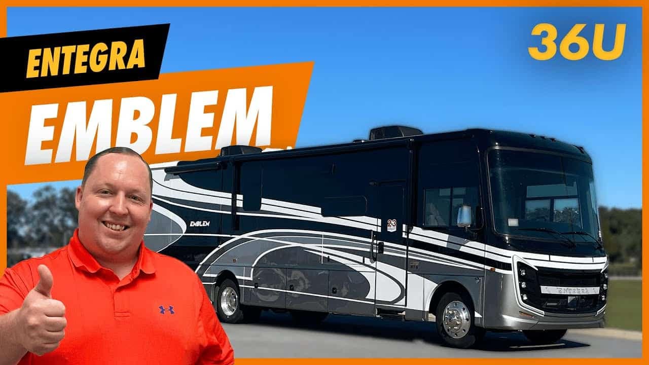 A man is giving a thumbs up to an Entegra Coach Emblem RV, impressed by its comfort and the model 36U.