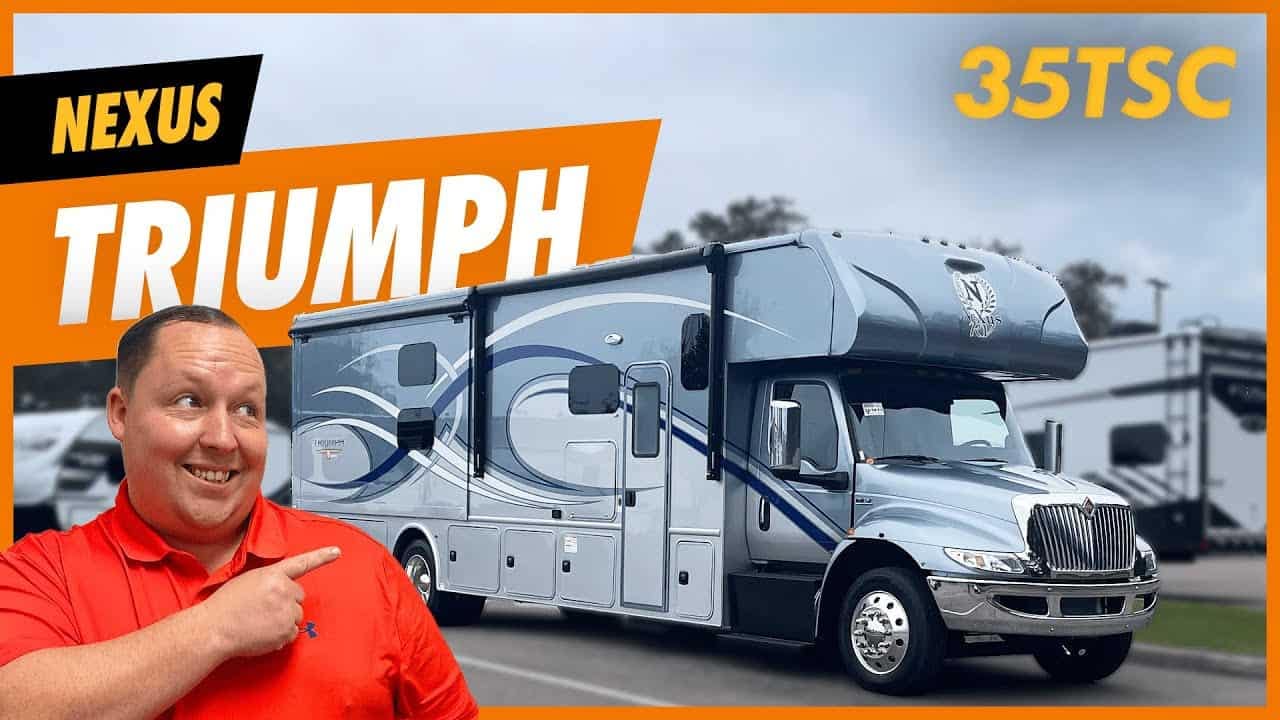 A man is posing in front of a 2023 Nexus Triumph RV.