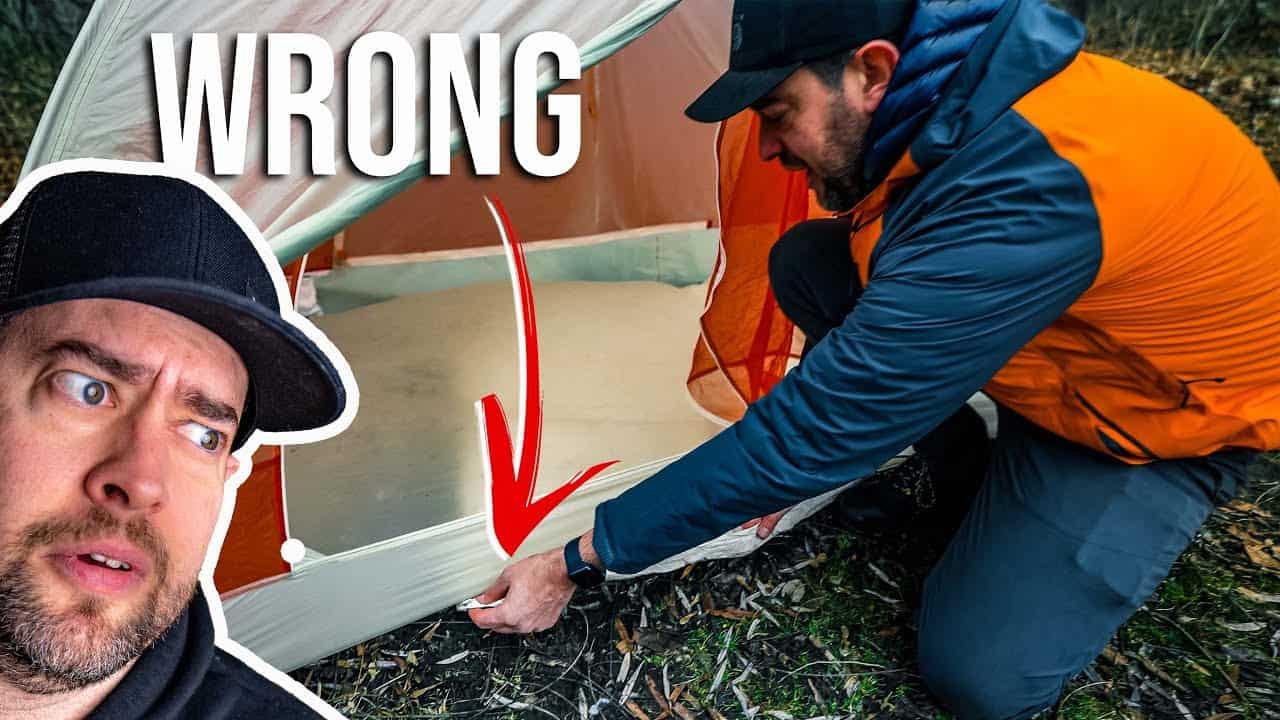 A man is looking at a comfortable tent with the word wrong on it.
