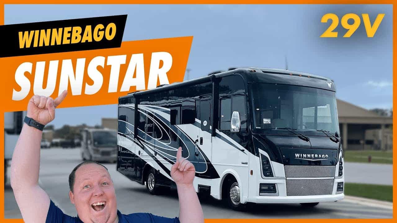 A man proudly holds up a Winnebago Sunstar RV, embarking on an exciting RV adventure.
