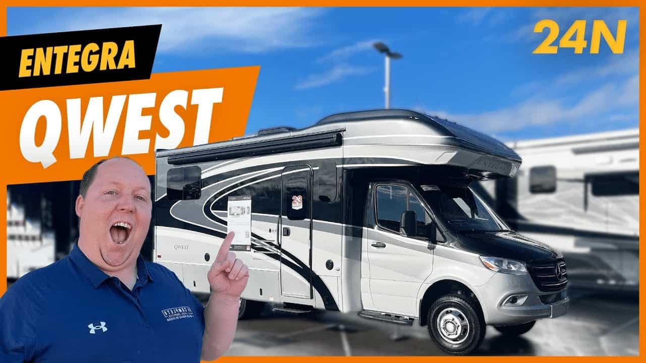 A man is standing in front of a comfortable Entegra Qwest motorhome.