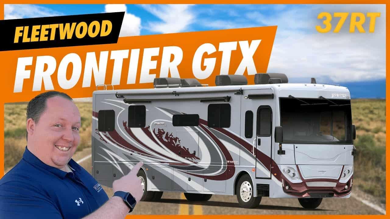 A man is standing in front of a spacious RV with the words Frontier GTX 37RT.