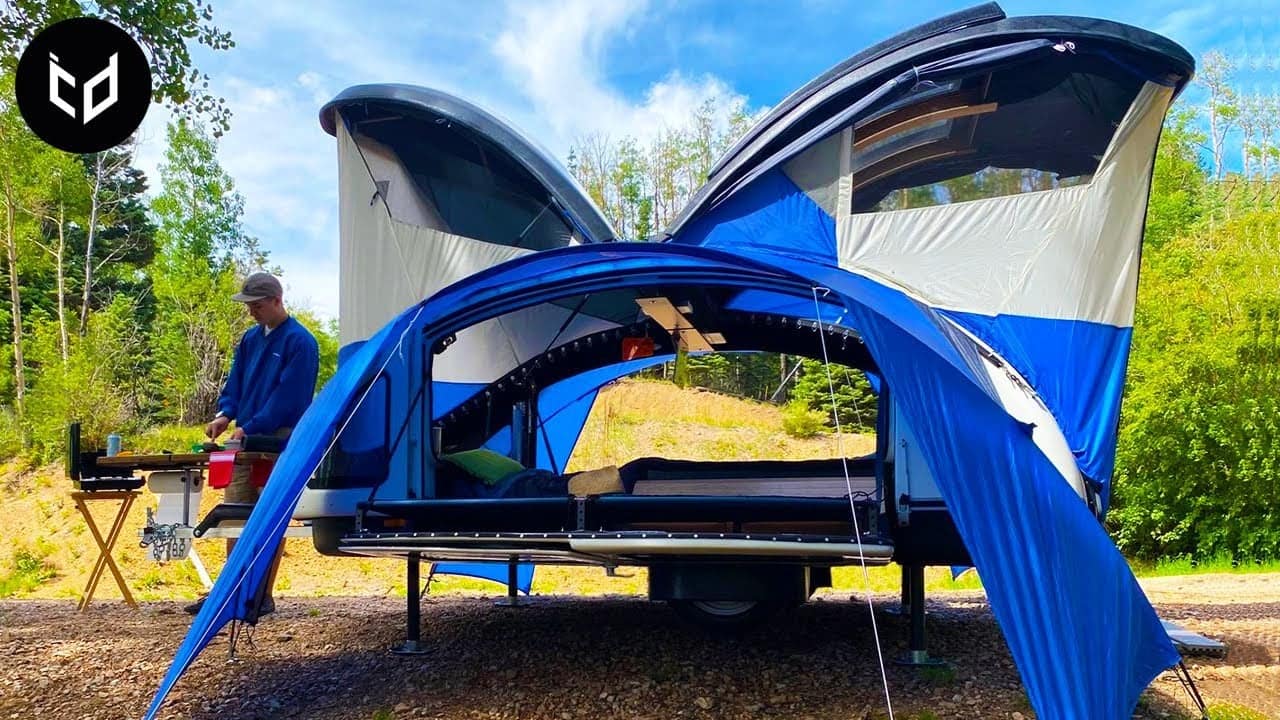 A man is revolutionizing camping by setting up a tent on a trailer, showcasing the latest invention in outdoor experiences.