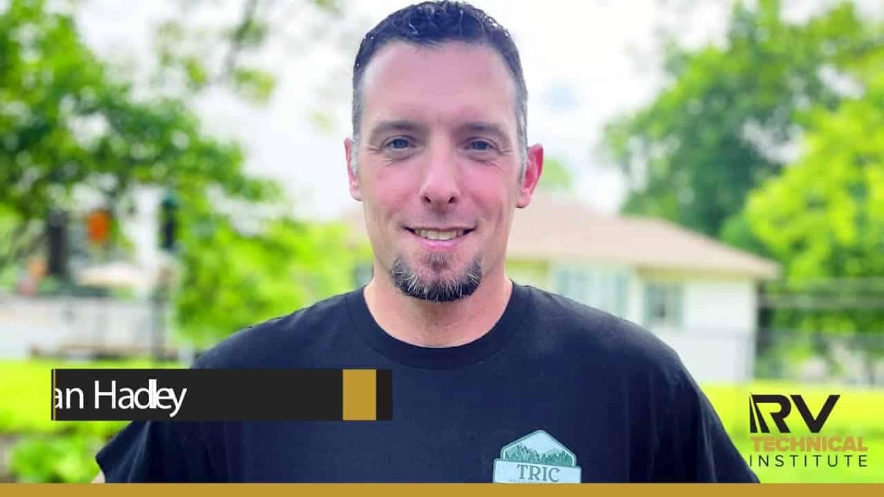 A Mobile RV Technician in a black shirt with the words in tadley.
