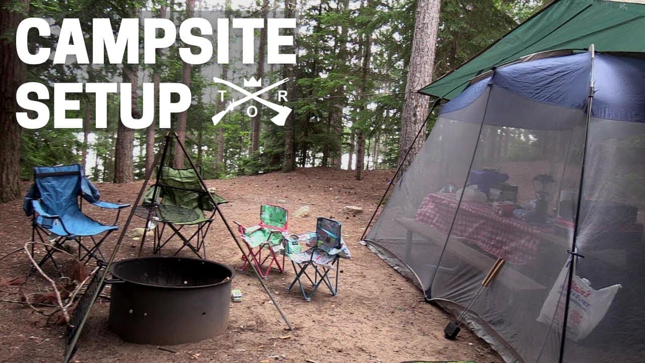 A campsite with a tent setup in the woods.