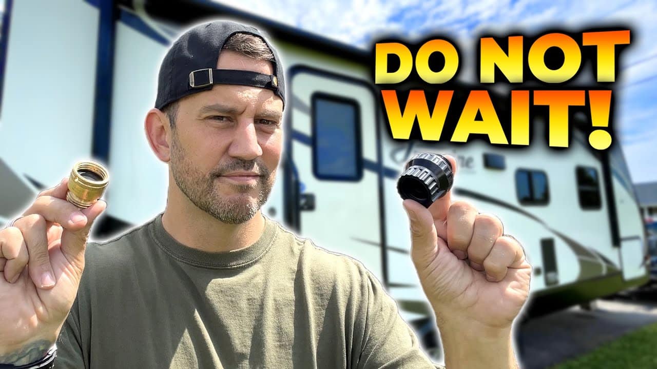 A man holding up a "do not wait" sign in front of an RV, giving essential RV tips.