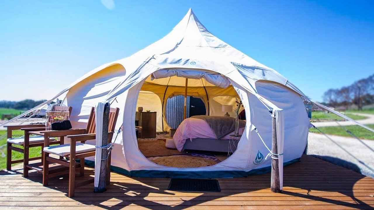 A luxury tent sitting on a wooden deck.