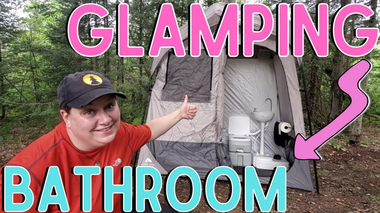 A woman is standing next to a glamping bathroom.