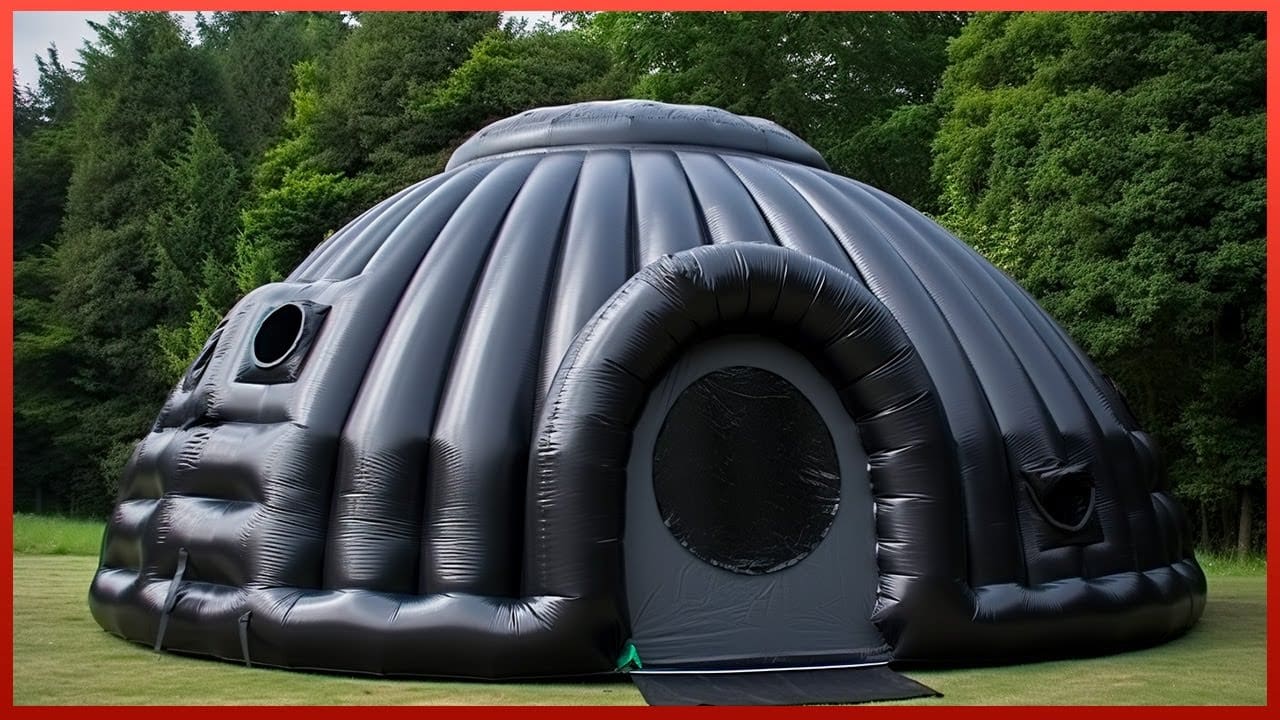 A black inflatable igloo perfect for camping adventures, sitting on a grassy field.