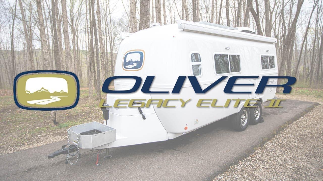 The Oliver Legacy Elite II, an innovative 2023 model, is calmly parked in a serene wooded area.