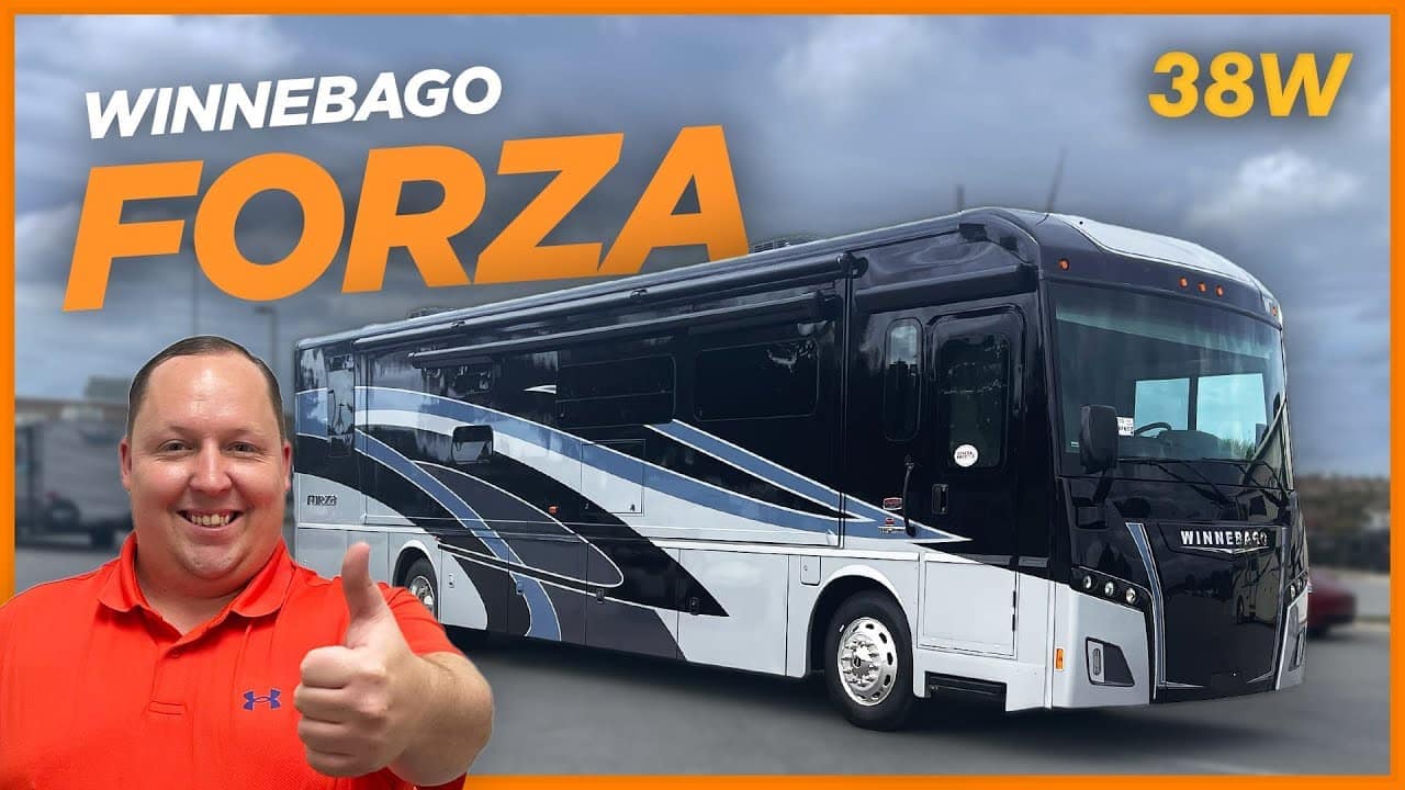 A man is giving a thumbs up to a Winnebago Forza 38W, the game-changing motorhome.