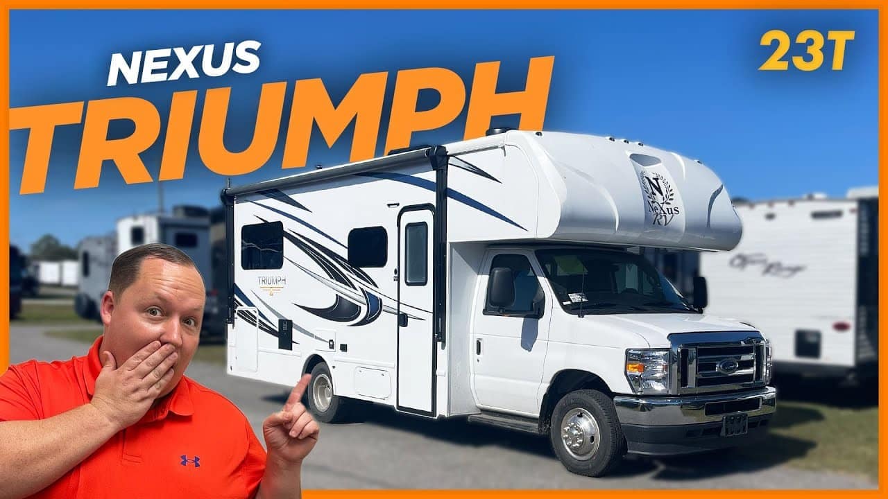 A man is standing next to a Compact Motorhome RV with the words Nexus Triumph 23T.