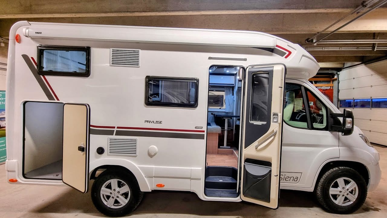 A white GiottiLine Siena 322 camper van is parked in a garage.