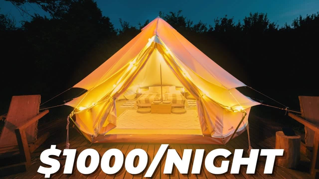 A tent lit up at night with the words "Glamping Airbnb $1000 / night.
