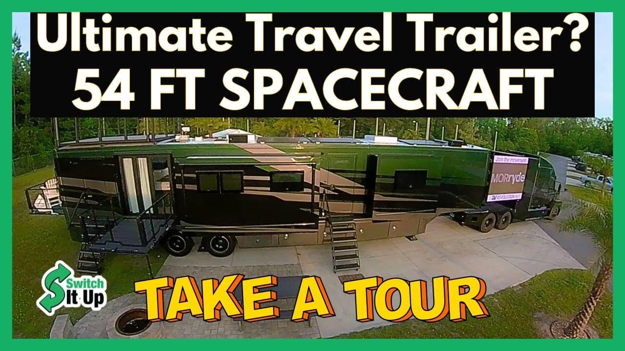 A 54-foot long luxury travel trailer parked in an open area, displayed as part of a "take a tour" auto draft promotional video.