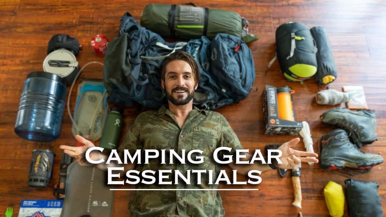 Man with auto camping equipment laid out on the floor.