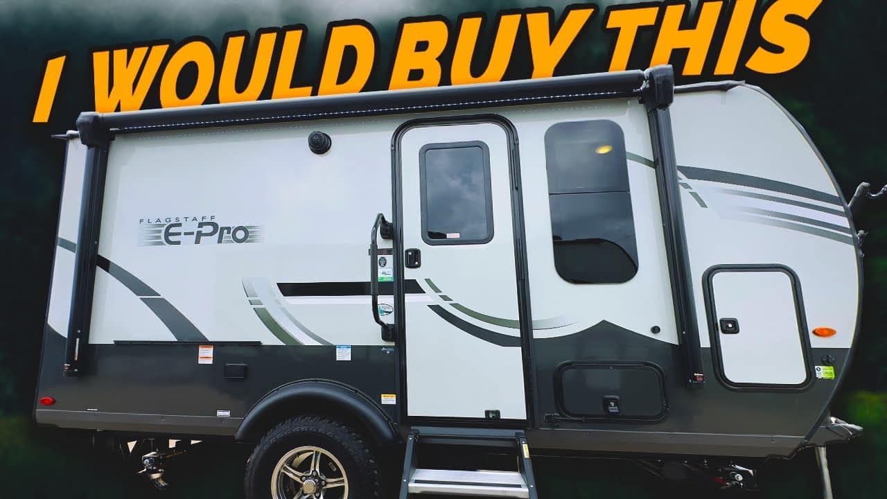 White and gray travel trailer with the text "Auto Draft" in yellow at the top against a smoky background.