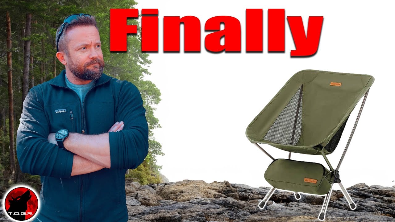 A man with a beard stands with arms crossed next to an image of a portable camping chair, with the phrase "Auto Draft" in large red text overhead.