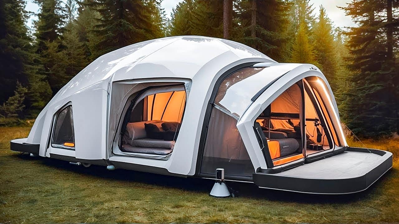 Modern, spacious camping tent set up in a forest clearing, featuring large transparent panels and a cozy interior visible through the entrance.