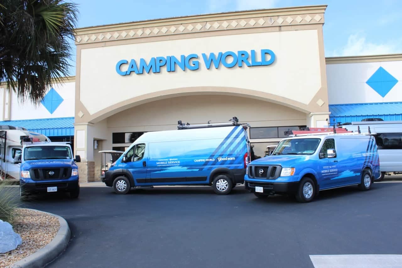 Three vans parked in front of a Camping World in Ocala.