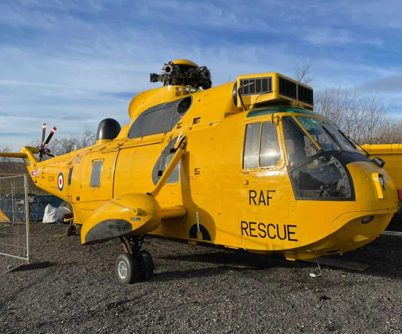 In Scarborough, a yellow RAF rescue helicopter is parked in a field next to glamping pods.