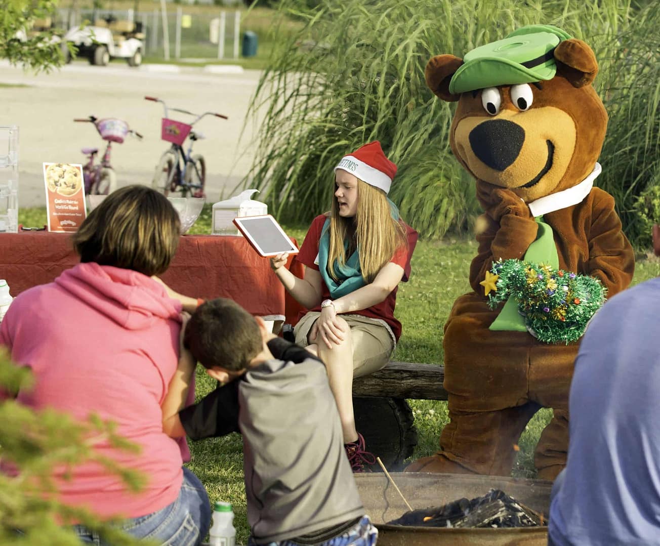 A brown teddy bear mascot at Jellystone Park during themed weekends.