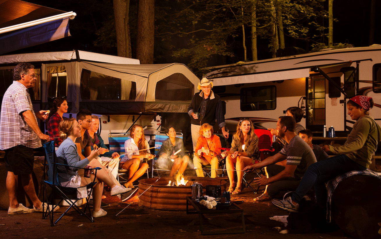 A group of people sitting around a campfire in New England.