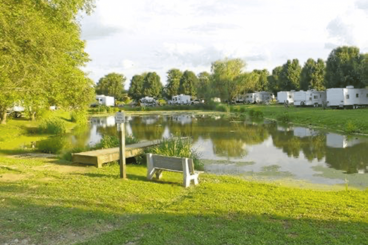 BEYONDER Camp, an rv park with a pond and a bench, is the ideal destination for a serene Memorial Day Weekend getaway.