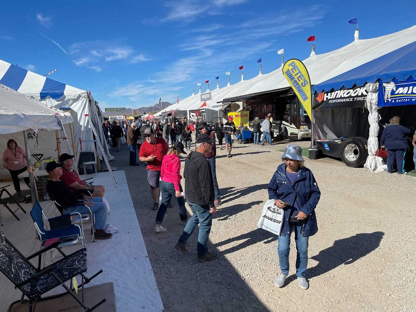 A crowd of people walking in front of Quartzsite tents.