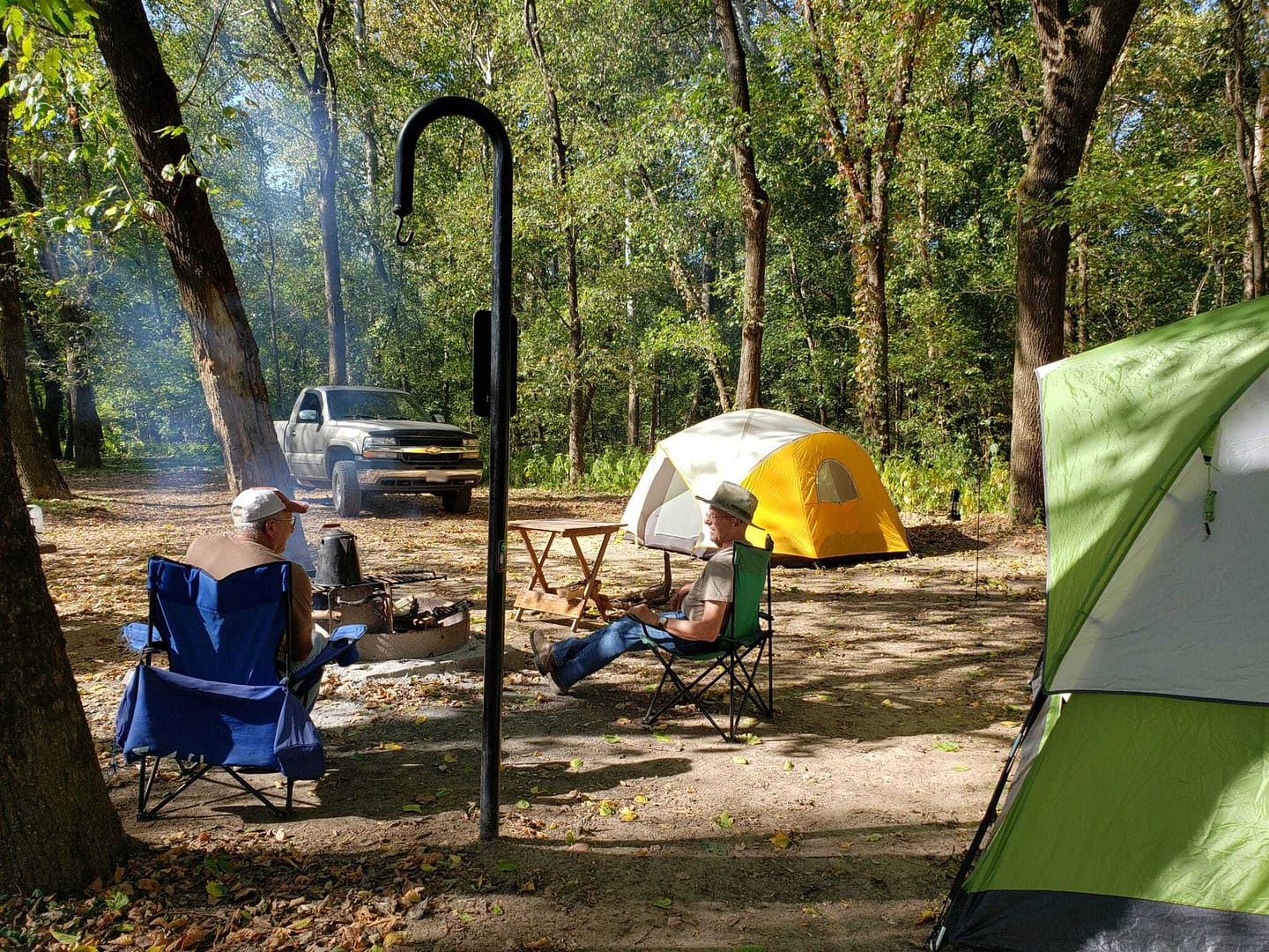 Two people sitting around a campfire in Ozark National Scenic Riverways.